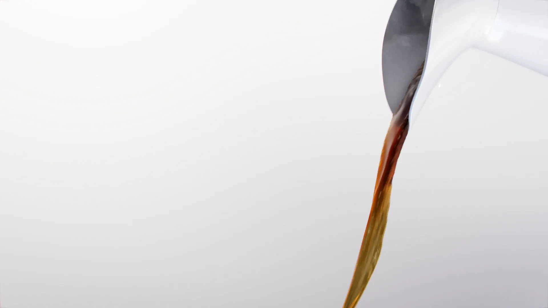 Close up image of coffee being poured from a pitcher. Still image from an animation made for Paulig City Coffee ad using liquid simulation and 3D animation.