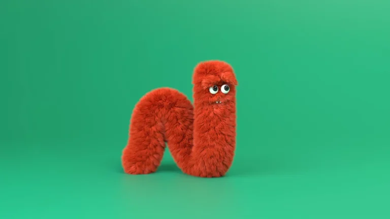 A fuzzy hairy worm character is crawling away. A still image from a 3D animation production for Antero.