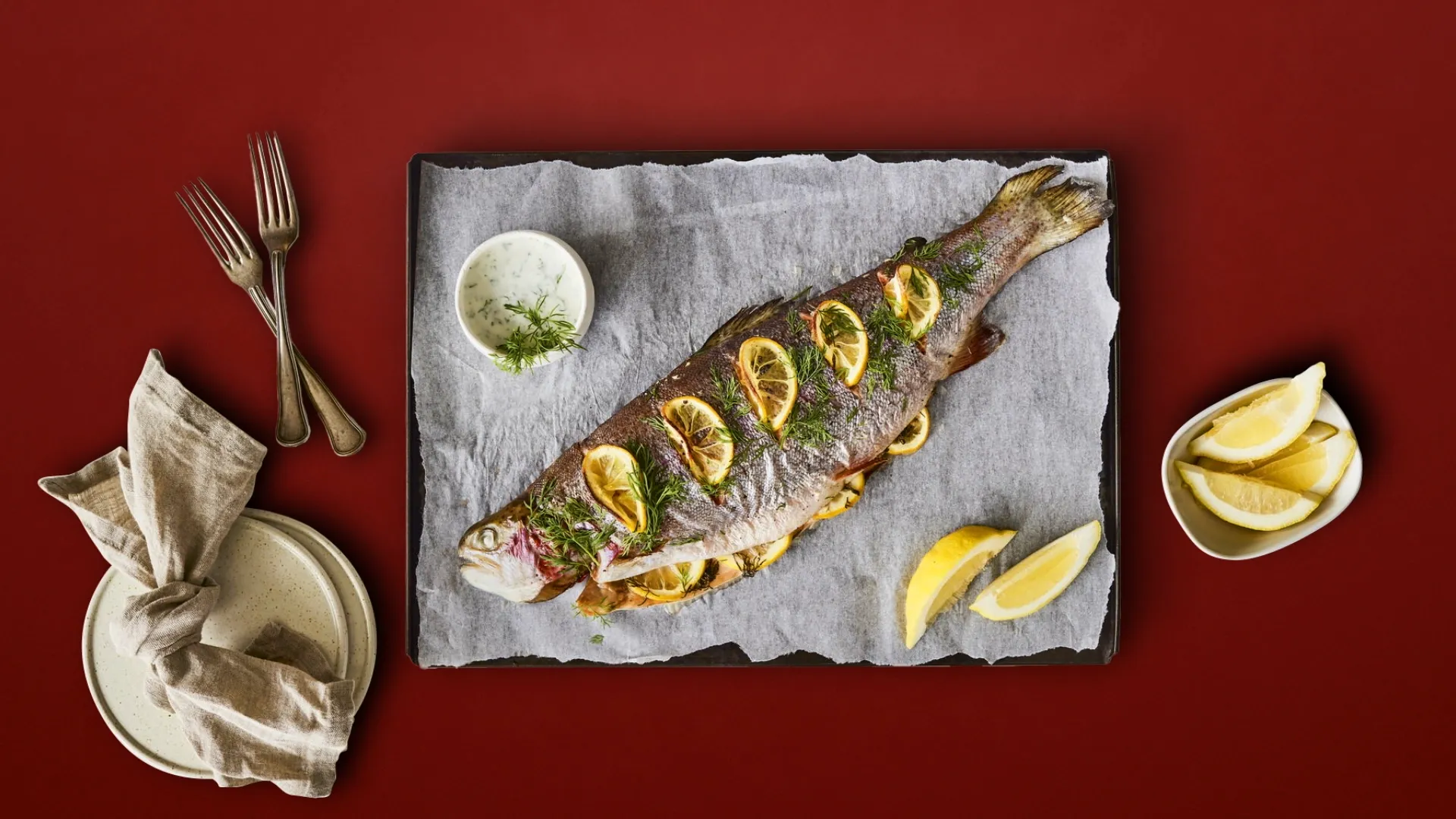 A photograph of a delicious oven fried whole salmon with some lemon and herbs.