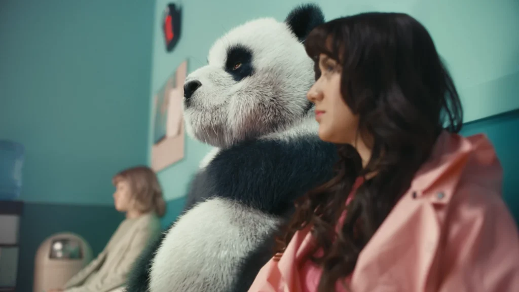 A content image from the Brink Helsinki blog post: Color Grading in Animation. In the image, there is a giant panda sitting in a waiting room. The image is a combination of filmed footage and 3D animation, composited and color graded to form a coherent single image.